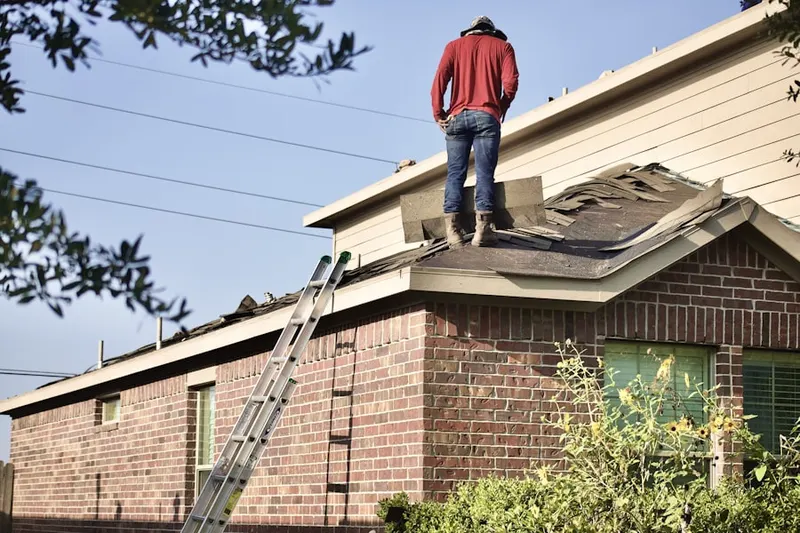Professional roofer working on a residential roof in Grand Forks